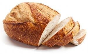 Loaf of bread partially sliced.