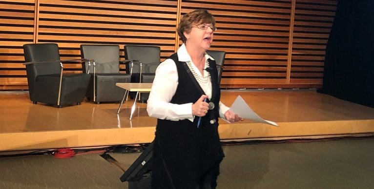 Woman in front of stage at Feed Opportunity event