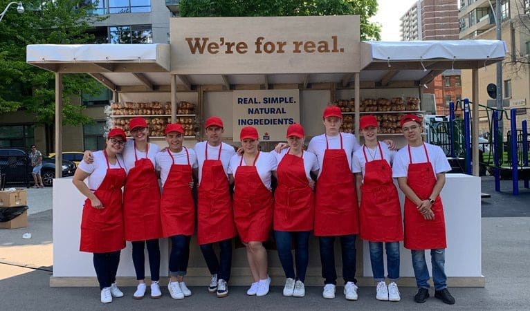 Servers in front of Maple Leaf's Pride parade stall