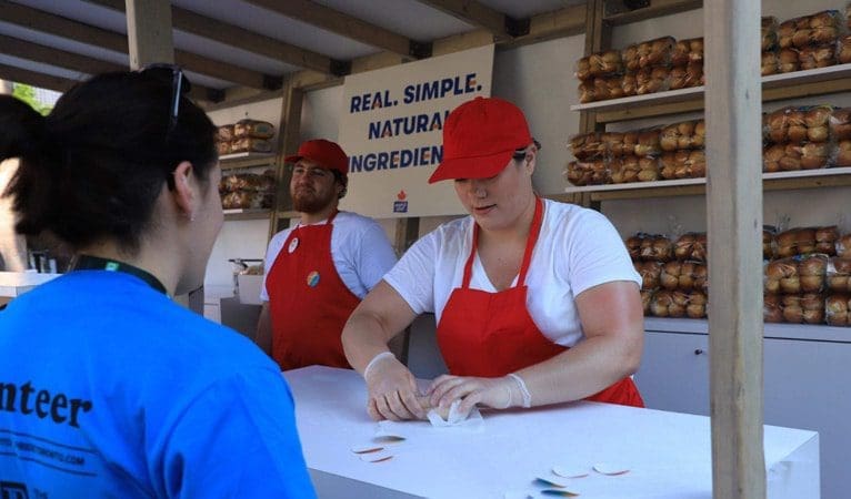 Serving customers at Maple Leaf Pride parade stall