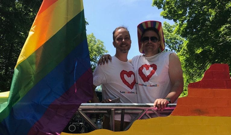 Two men posing for picture at Pride parade