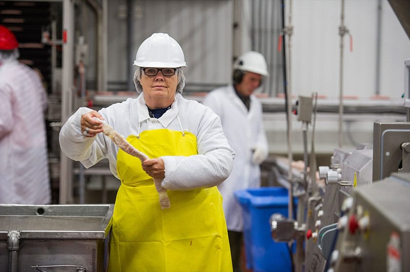 Macleod worker linking sausage