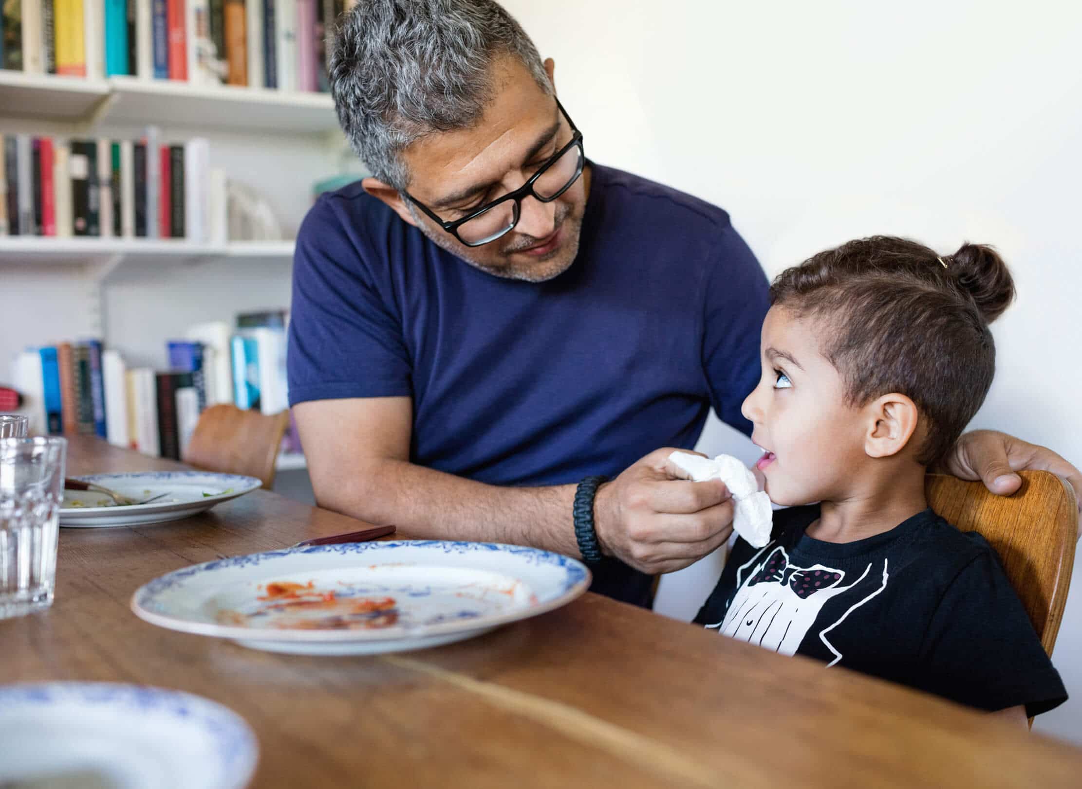 Father and son eating a meal together