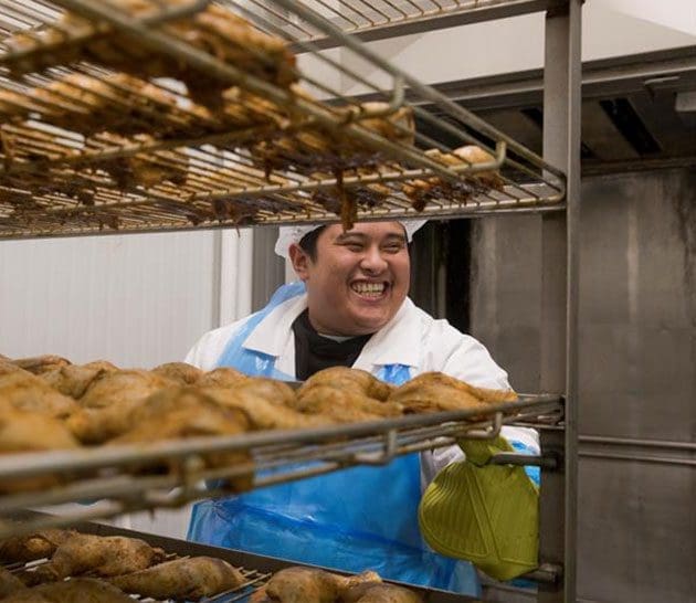 A Team Mmeber is cooking Maple Leaf chicken in our test kitchen