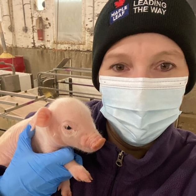 LeeAnn holding a baby piglet