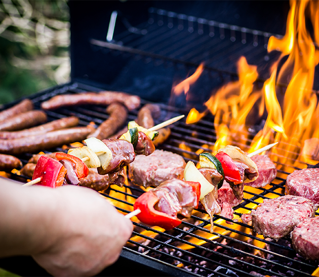 sizzling meats being cooked on a BBQ