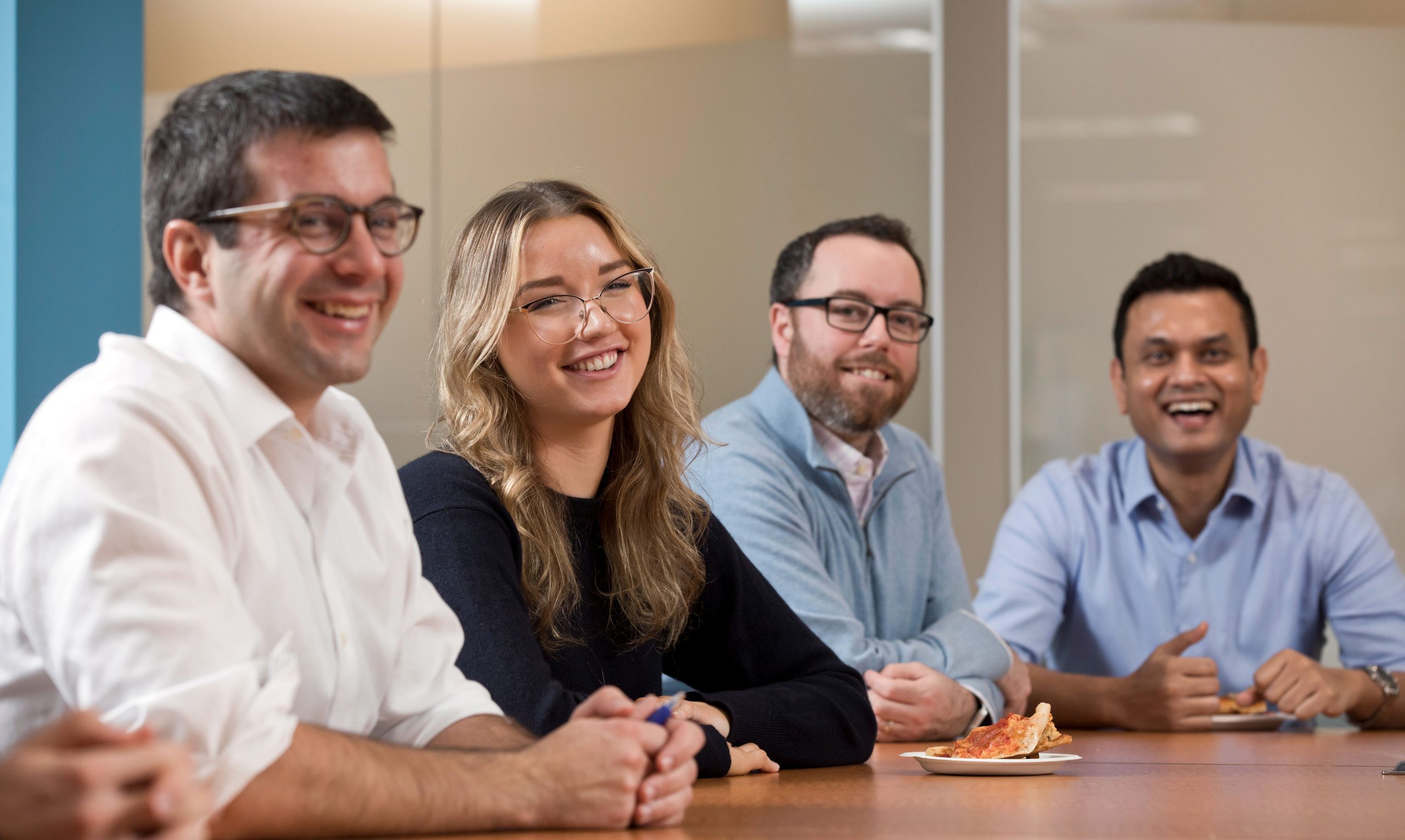 Smiling people around a conference table