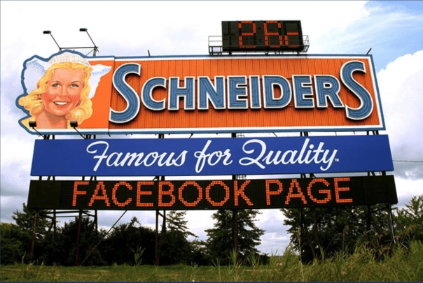Schneiders sign on Highway 401 in Ontario. It reads: "Schneiders. Famous for Quality. Facebook page" 