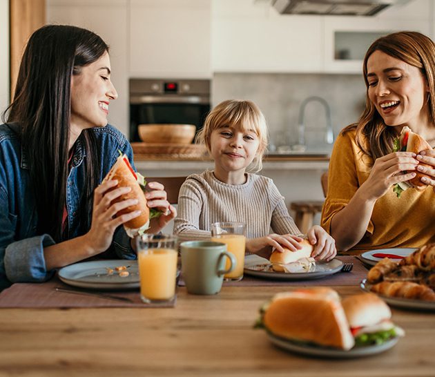 Family sharing sandwiches for lunch