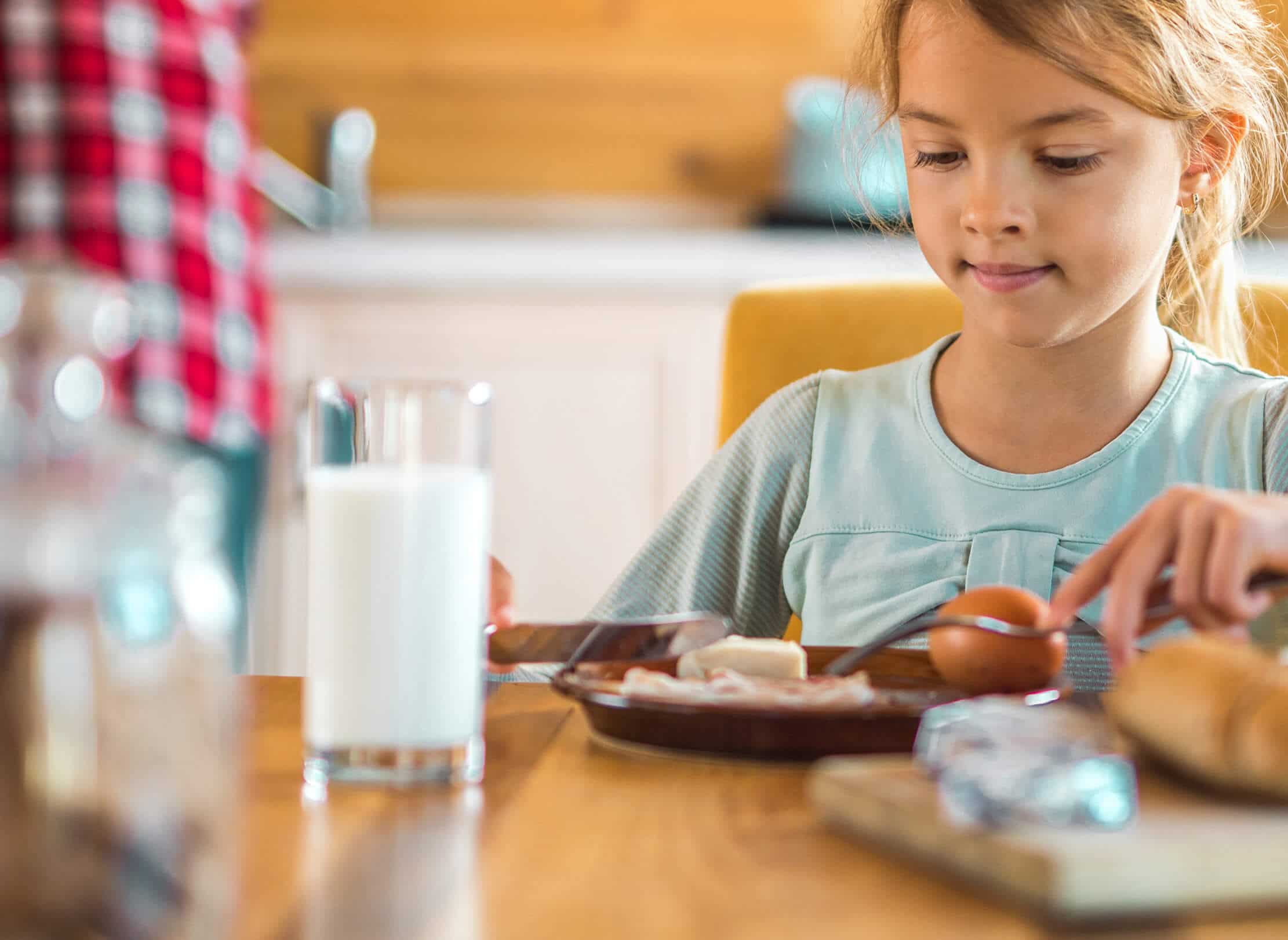 Young girl eating breakfast.