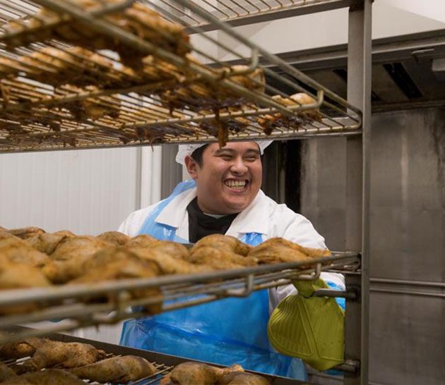 Team Member cooking Maple Leaf chicken