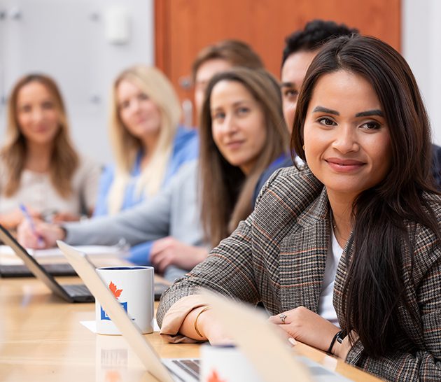 Meli, Laura, Mackenzie, Daisy, - dsitting together at a meeting table